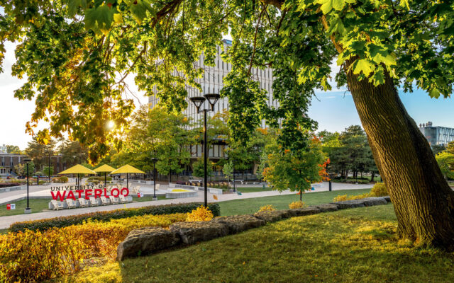 View of UWaterloo main sign in front of DP library in spring